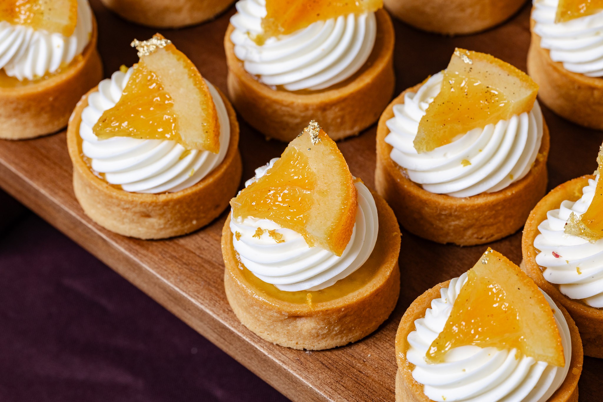 Orange tarts with cream and candied citrus at a Callebaut dessert presentation